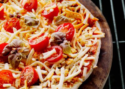 Pizza with Fresh Mozzarella,Tomatoes and Basil on the BBQ, cooking on a Pizza Stone